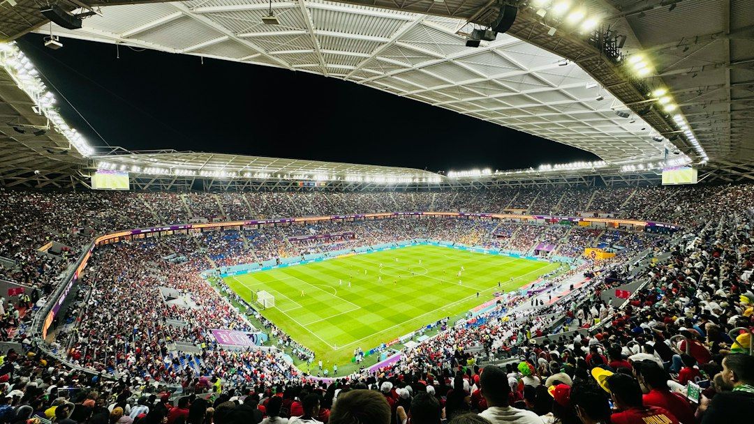 soccer stadium floodlights night match crowd no team crest