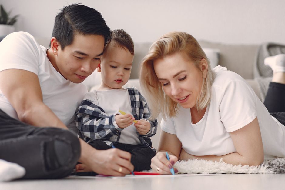 Thai parents with children relaxing home