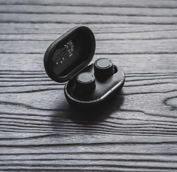 wireless earbuds charging case tech workspace