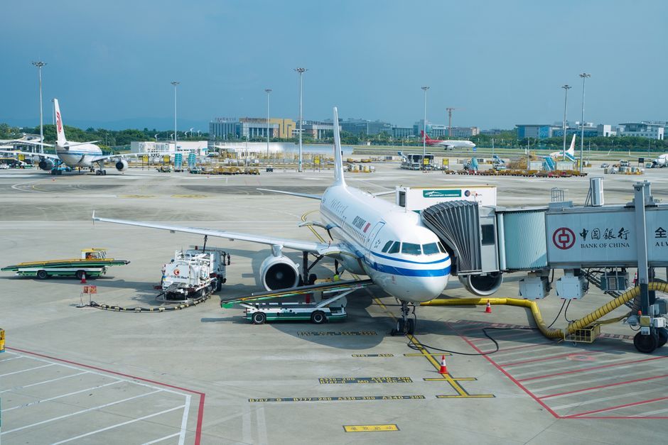 airplane parked at international airport terminal gate daytime
