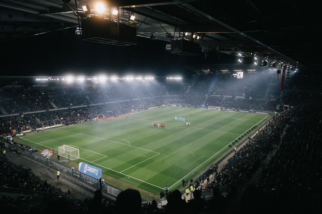 soccer stadium floodlights night match crowd no team crest