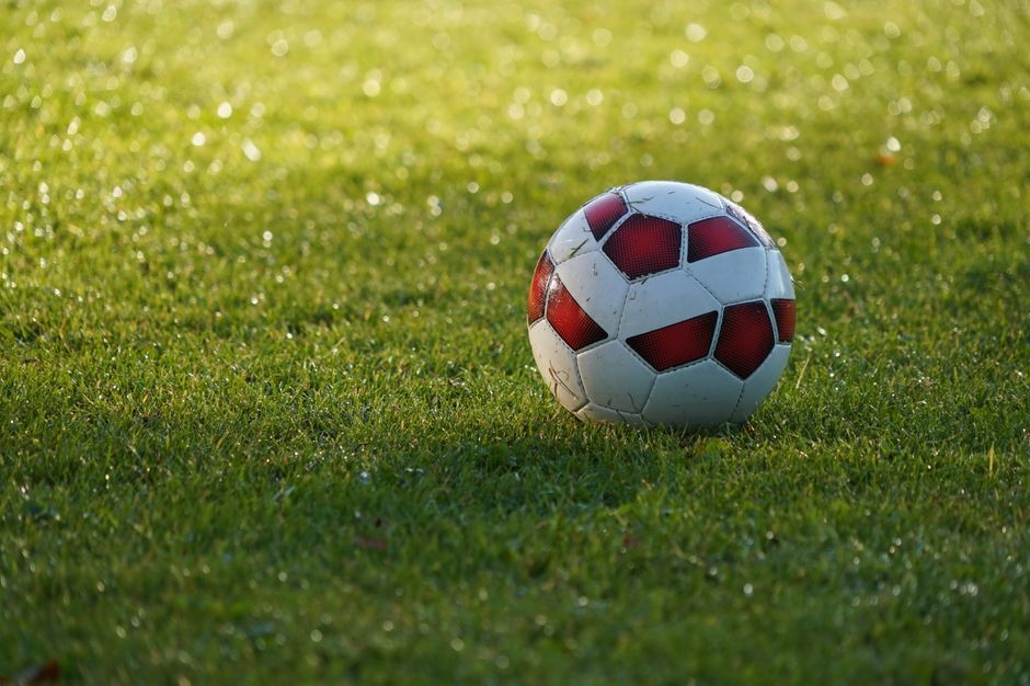 soccer ball grass field close up no team crest