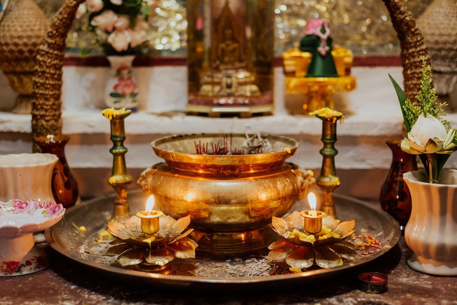 Thai Buddhist temple altar offerings candles flowers Bangkok