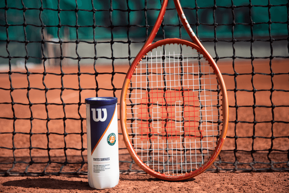 tennis racket and tennis balls on court