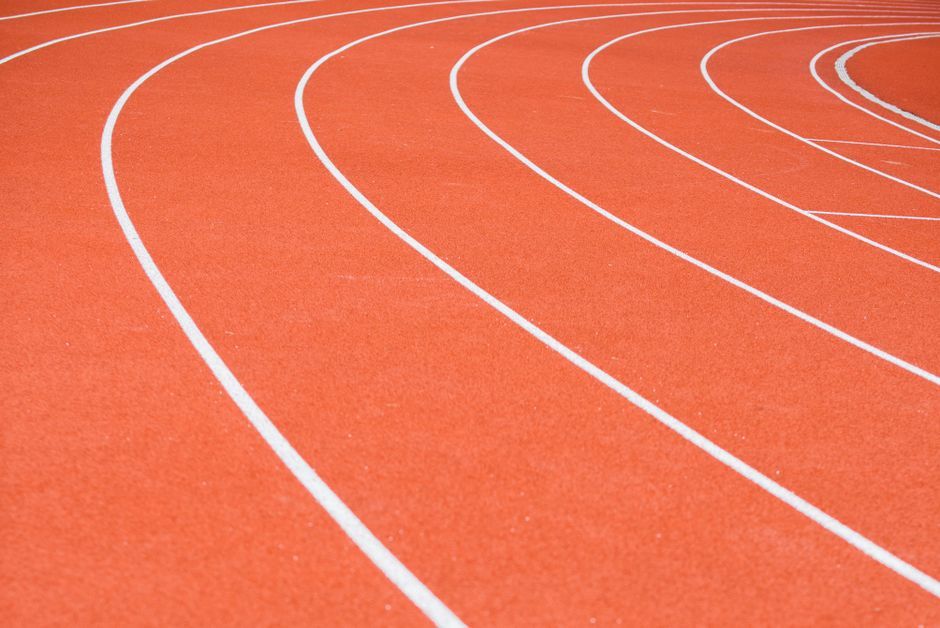 professional track and field athlete running stadium
