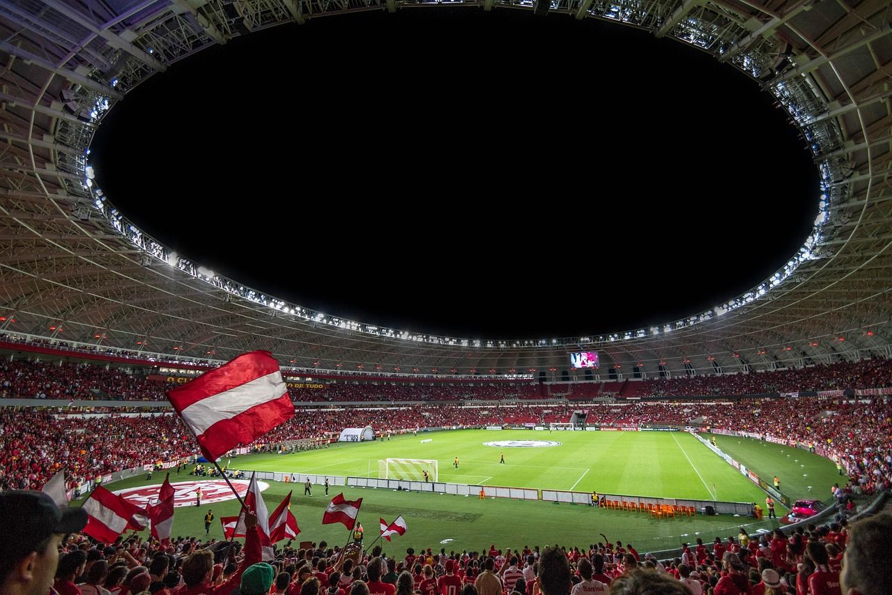 soccer stadium floodlights night match crowd no team crest