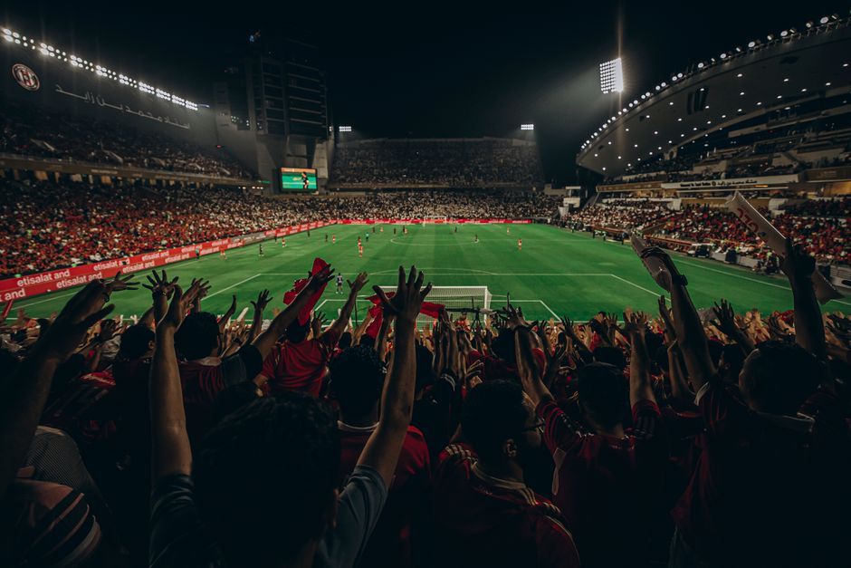 soccer stadium floodlights night match crowd no team crest