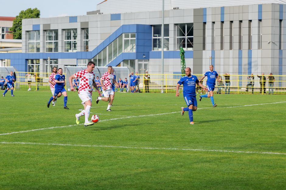 soccer match action pitch green grass no team crest