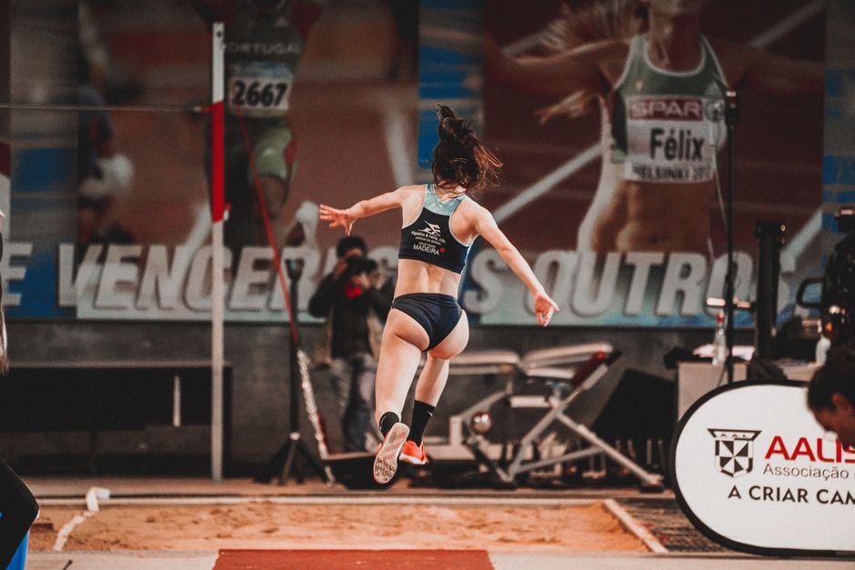 female athlete long jump track and field stadium