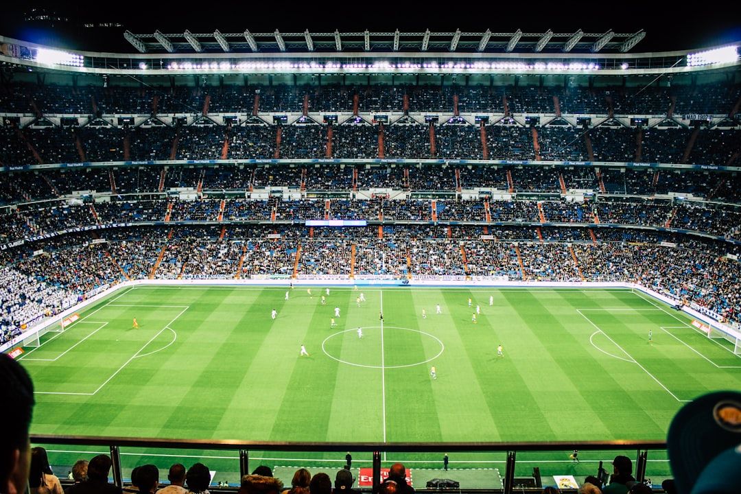 soccer stadium floodlights night match crowd no team crest
