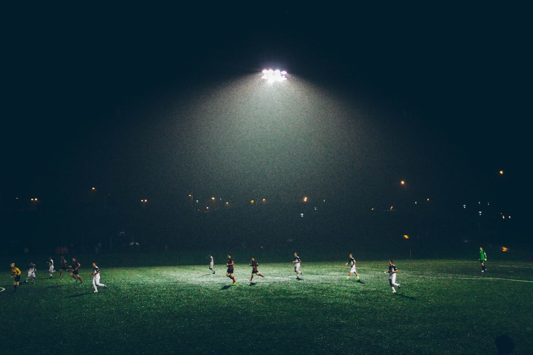 soccer stadium floodlights night match crowd no team crest