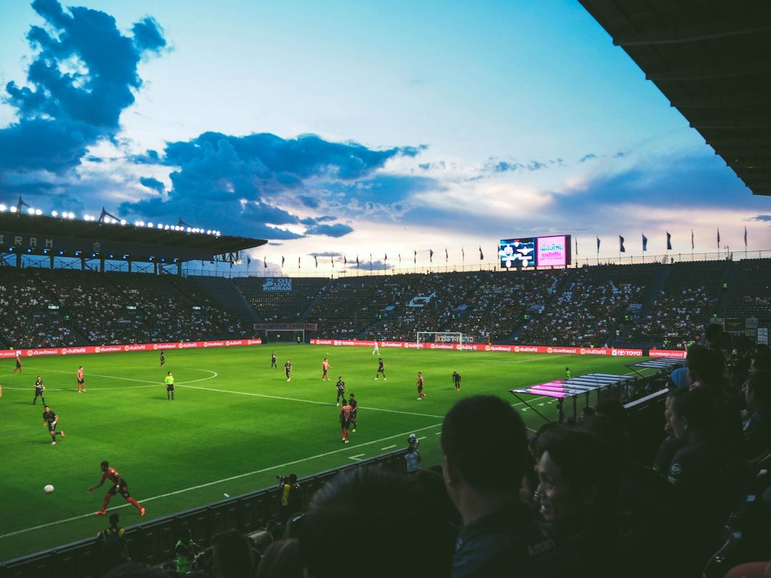 soccer stadium floodlights night match crowd no team crest