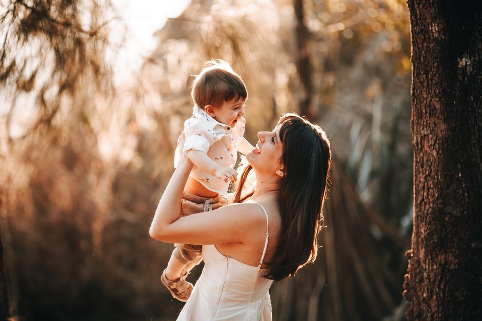 mother holding young child warm indoor lighting Thailand