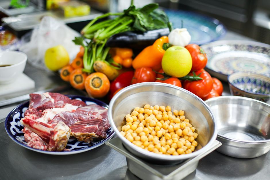 fresh vegetables and meat ingredients on kitchen table