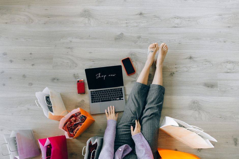 UK woman reviewing online fashion shopping list laptop