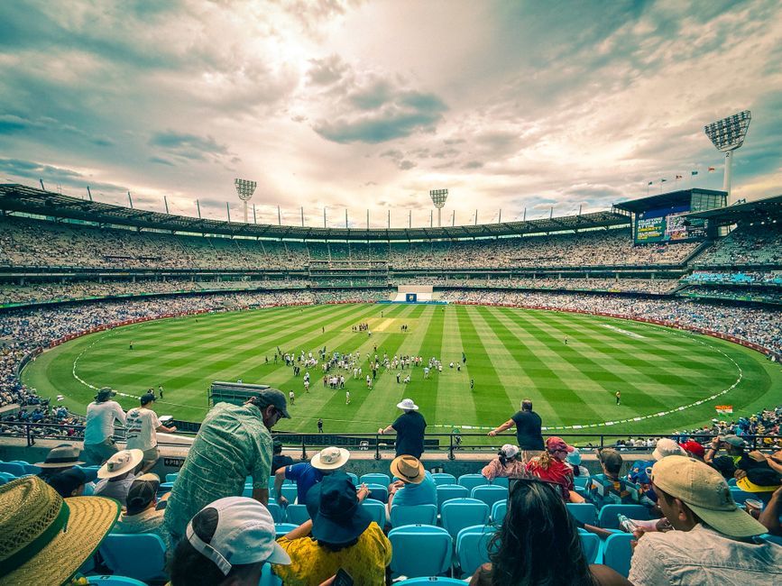 cricket stadium floodlights night match crowd no team crest