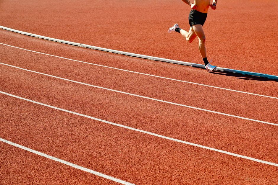athlete running track stadium