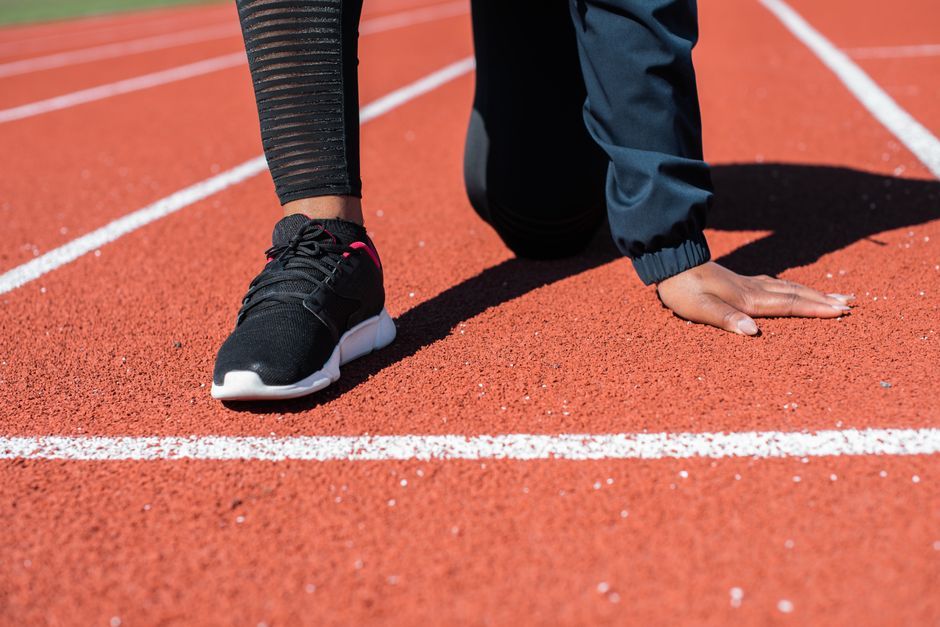 female runner sprinting on track