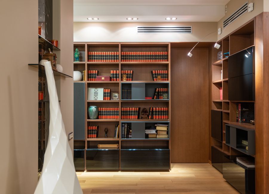 Rome apartment interior custom bookcase blue joinery
