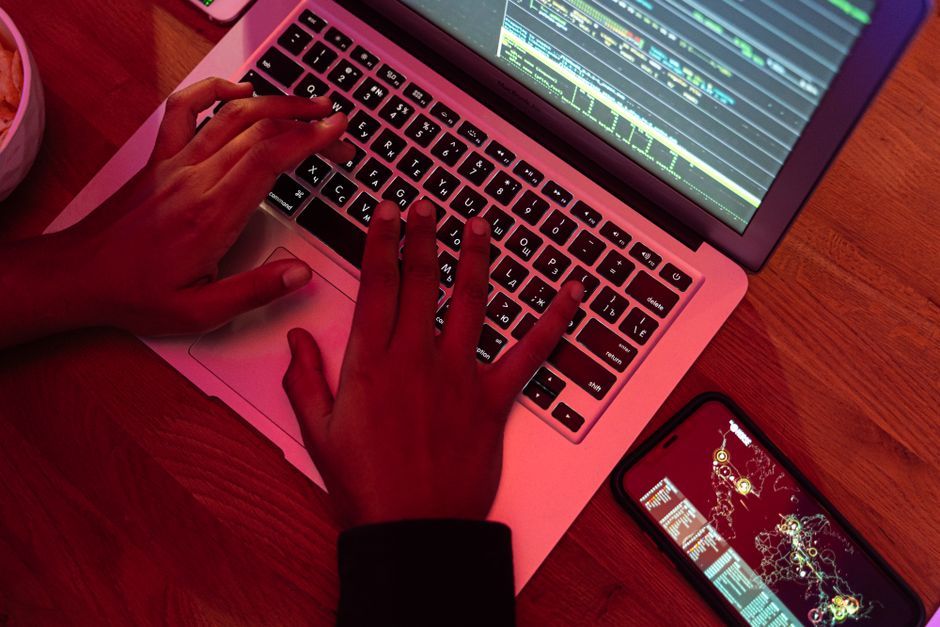 programmer typing code on mechanical keyboard close up workspace