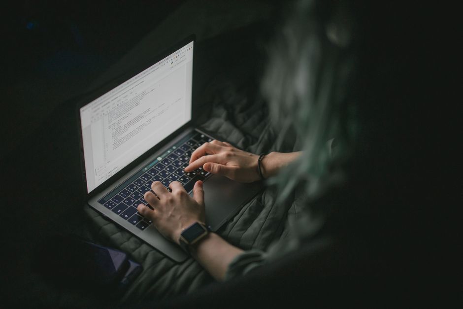 software developer writing code workspace laptop