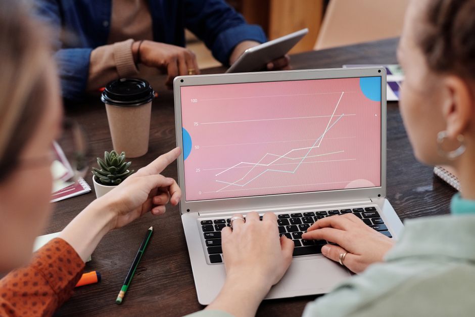 business team working on laptop data analysis