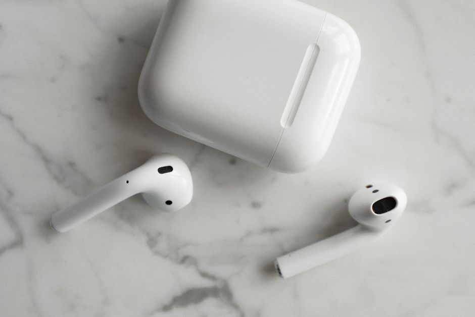 white wireless earbuds charging case