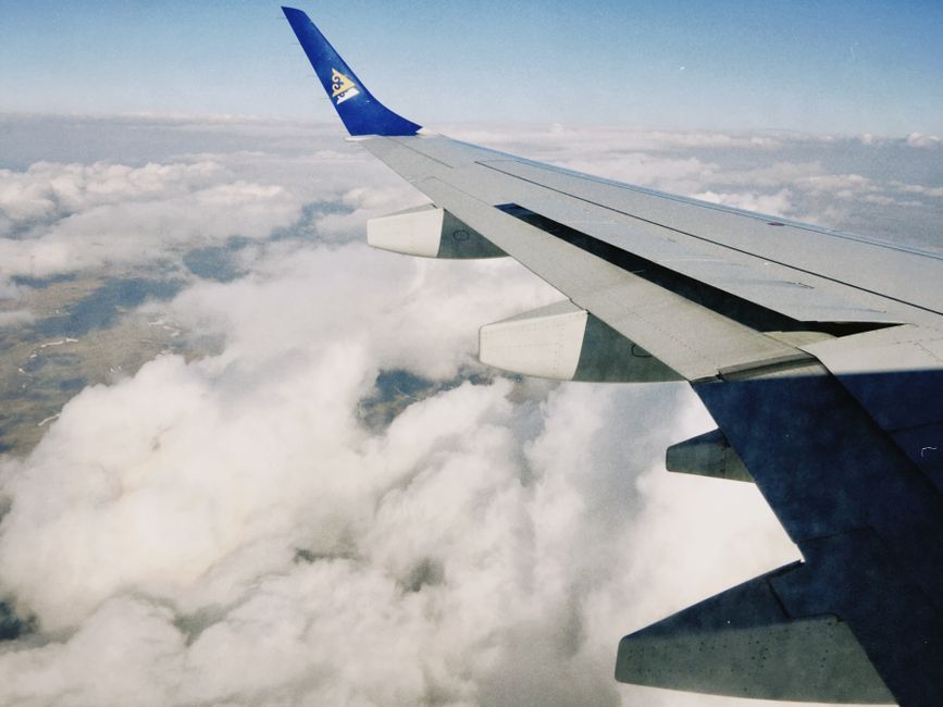 commercial aircraft airplane wing view clouds sky