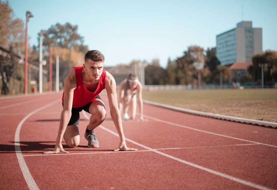 sprinter running on athletic track stadium