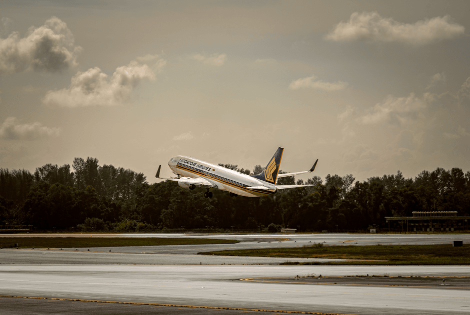UK passenger airplane taking off from airport runway