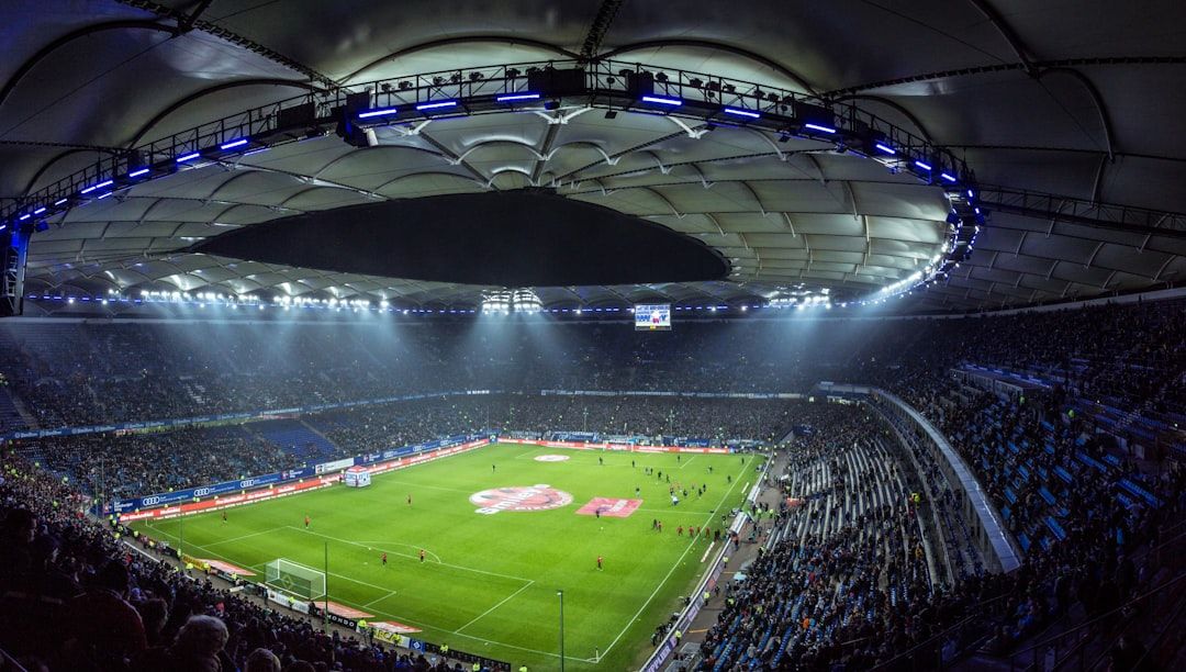 soccer stadium floodlights night match crowd no team crest