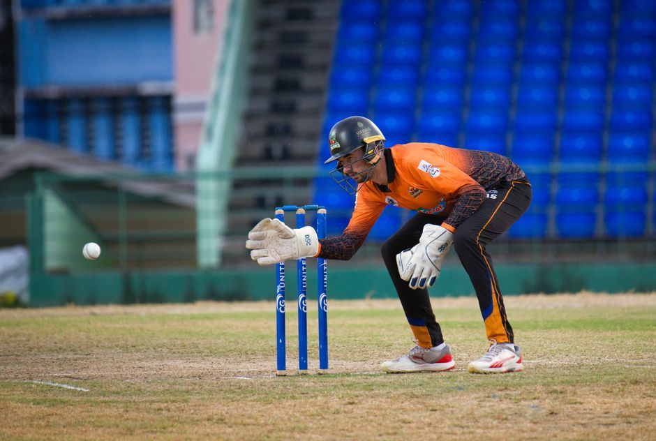 cricket player fielding action stadium