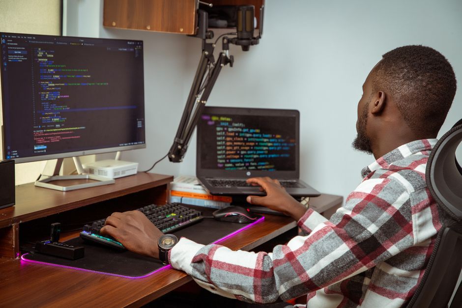 software developer working on laptop office desk workspace