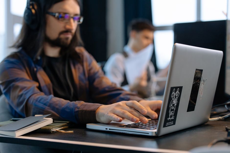 software developer working on laptop in modern office