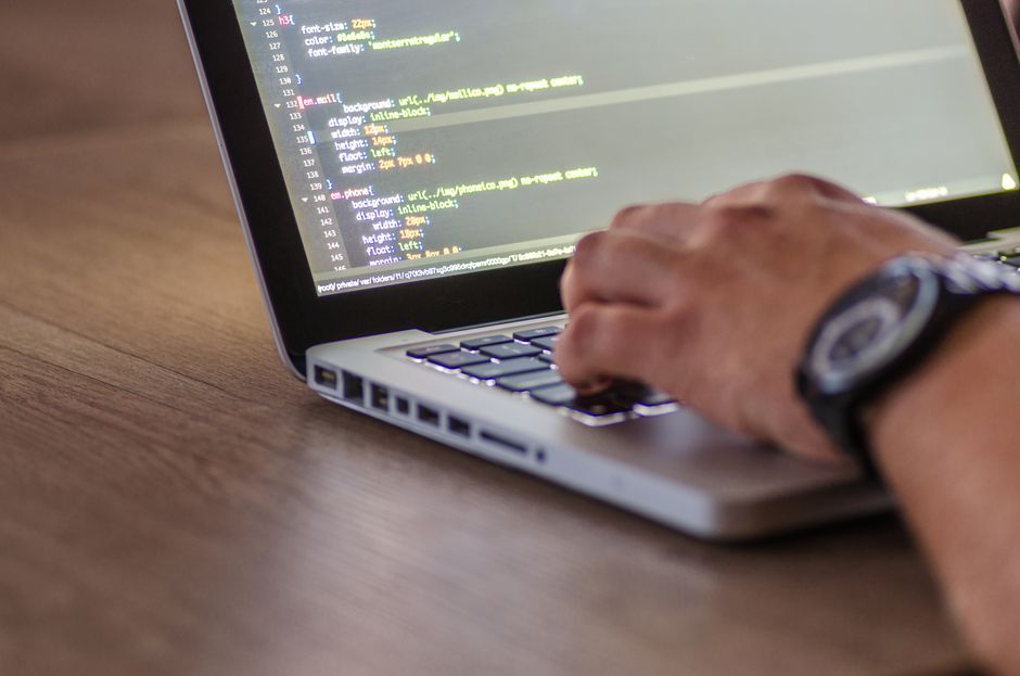 software developer writing code laptop computer screen workspace no logo