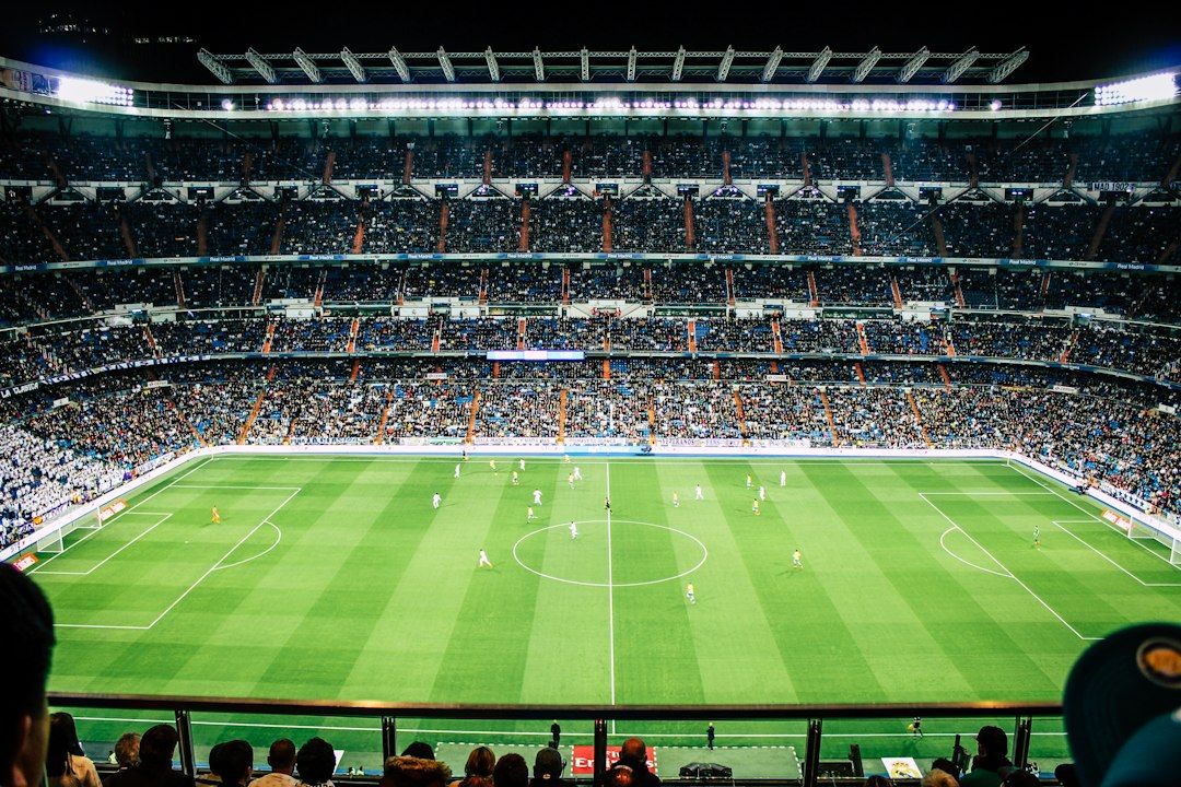 soccer stadium floodlights night match crowd no team crest
