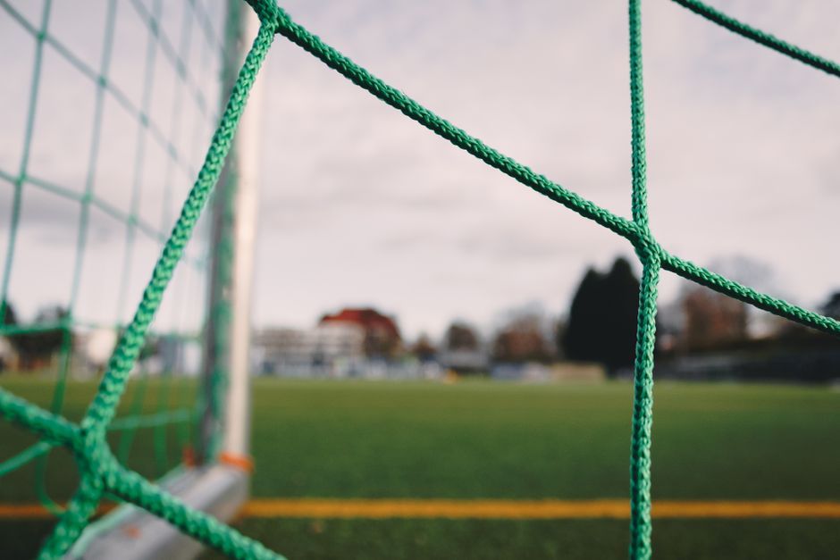 soccer match stadium grass field close up no team crest