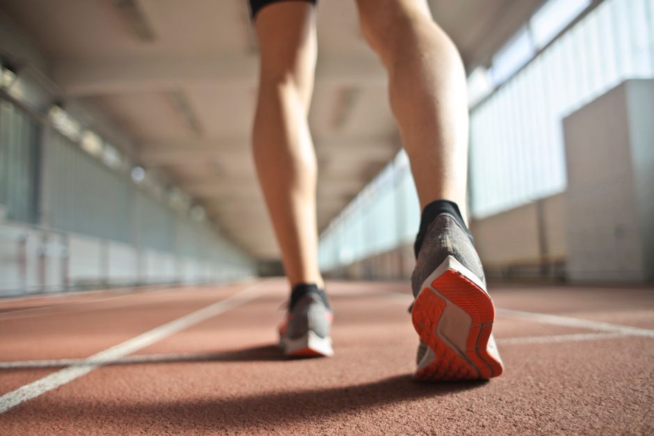 female sprinter running track stadium