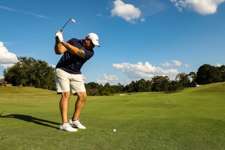 golf player swing iron club golf course