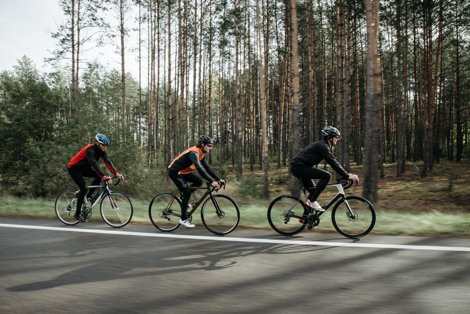 cyclists riding bicycle through europe landscape