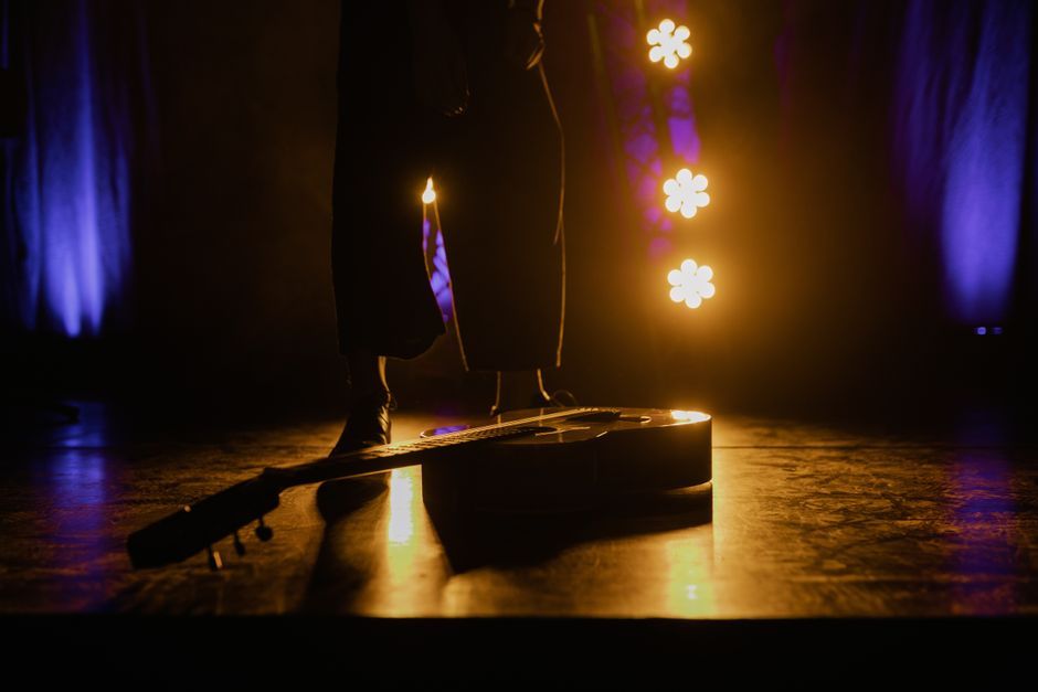 acoustic guitar performance stage lights concert venue