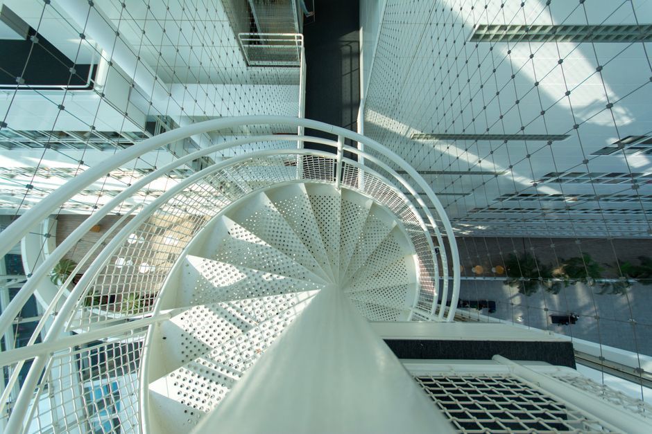 modern interior spiral staircase office building atrium Spain