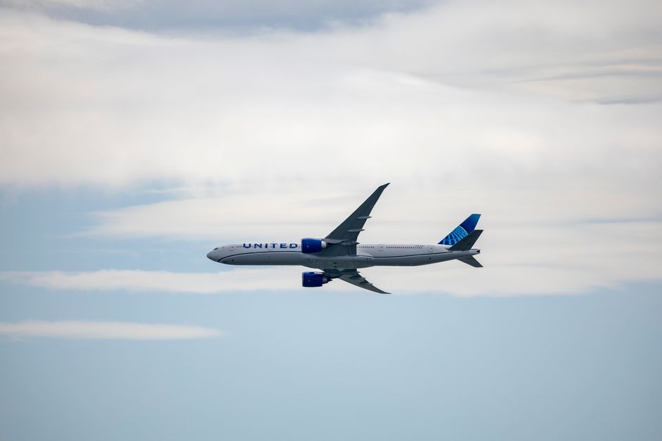 commercial airliner airplane flying in sky daytime