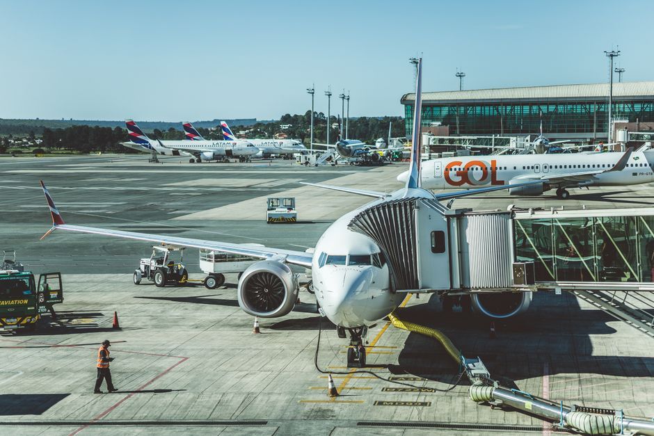 commercial aircraft parked at airport gate tarmac