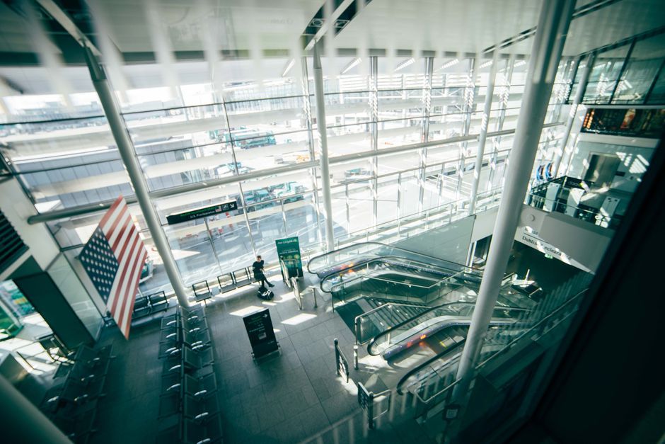 young professional checking smartphone airport lobby