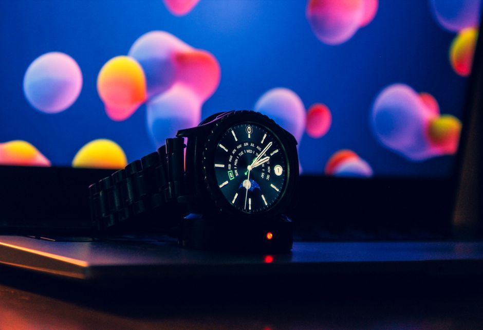 smartwatch charging on office desk workspace