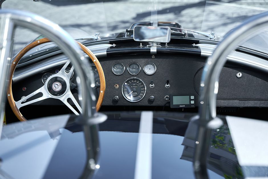 classic sports car cockpit steering wheel gauges interior