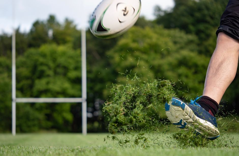 rugby ball grass field close up no team logo