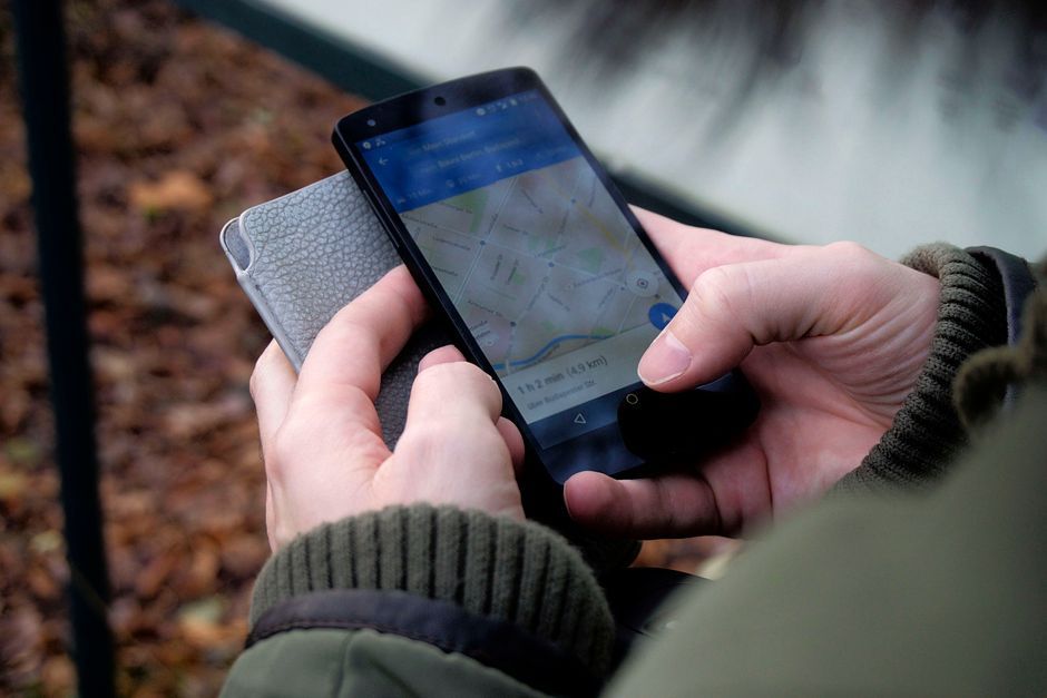 traveler using smartphone app hotel search