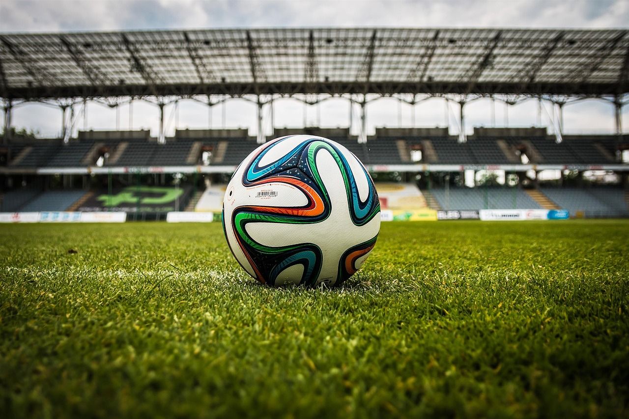 soccer stadium floodlights night match crowd no team crest